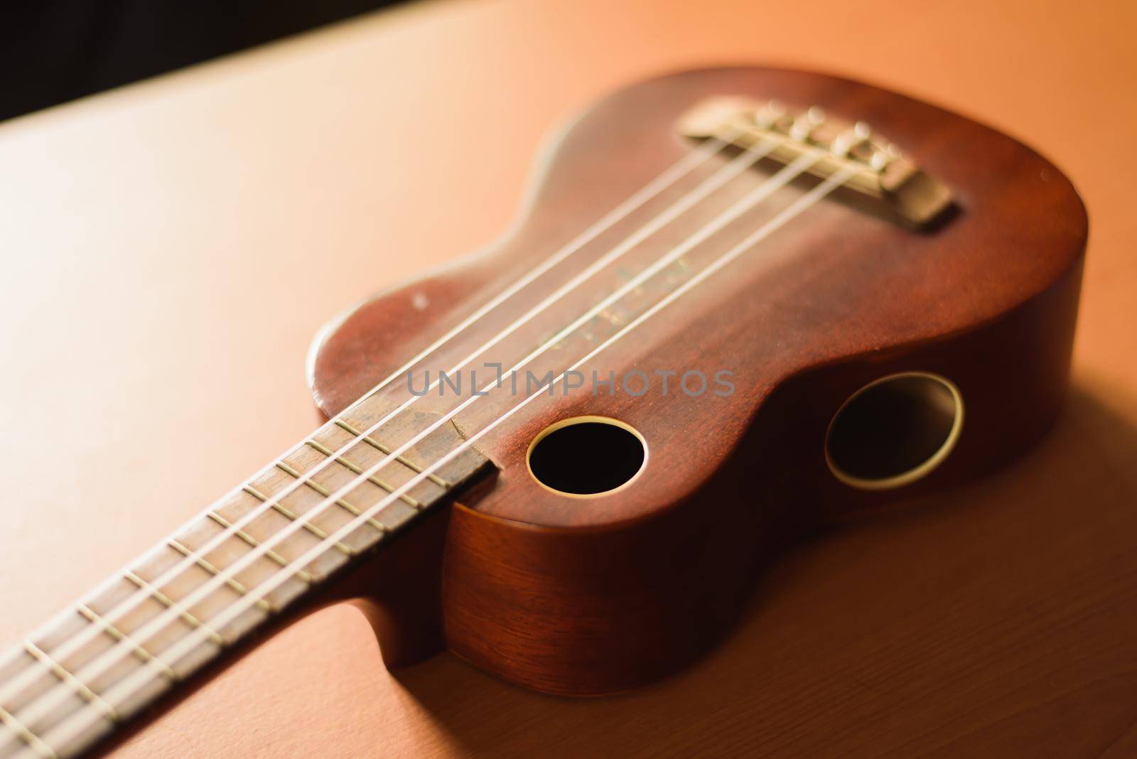 Vintage ukulele on wooden table