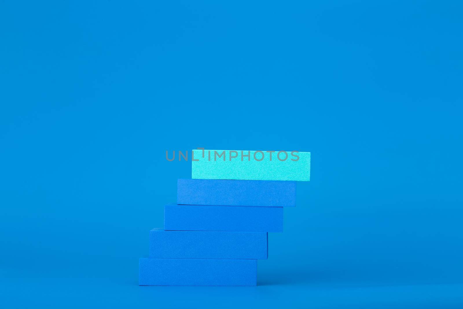 Business or personal development trendy modern concept. Ladder of success. Blue blocks as ladder on blue background with copy space