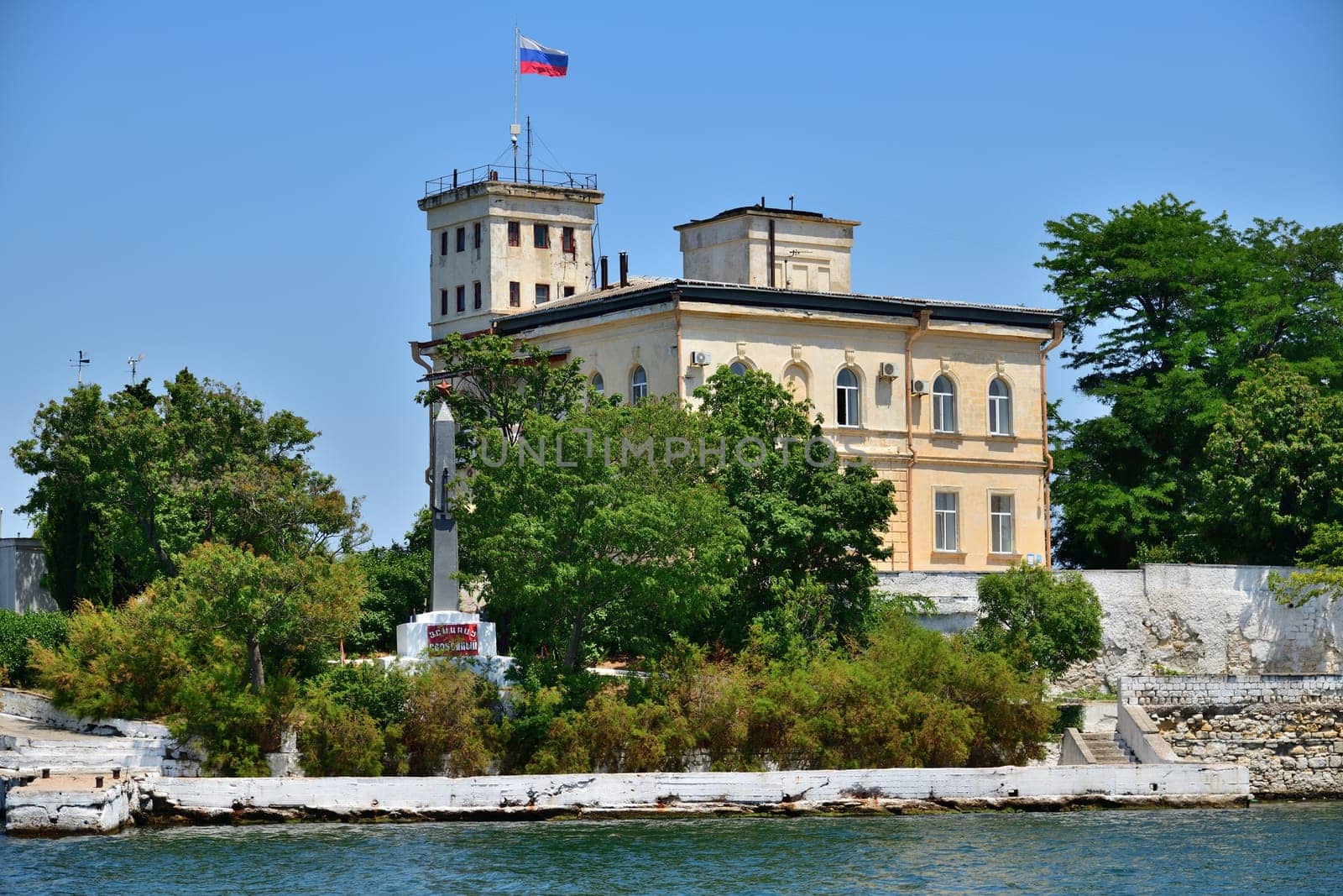 Sevastopol, Crimea - July 3, 2019. The building of Naval Hospital, founded in 1783 and monument to a destroyer Svobodny on Pavlovsky Cape