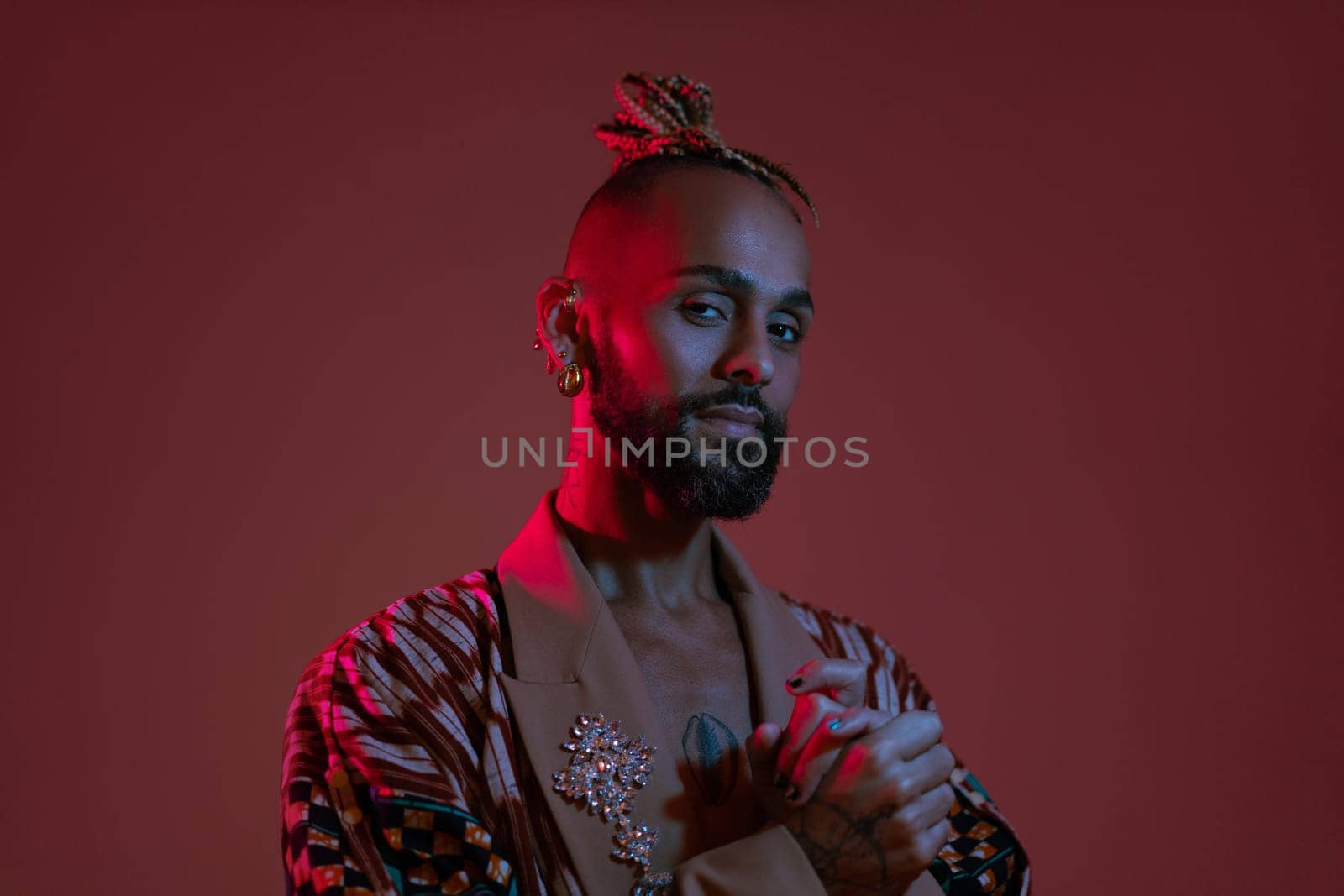 Retro wave or synth wave portrait young happy serious african-american man at studio. High Fashion male model in colorful bright neon lights posing.