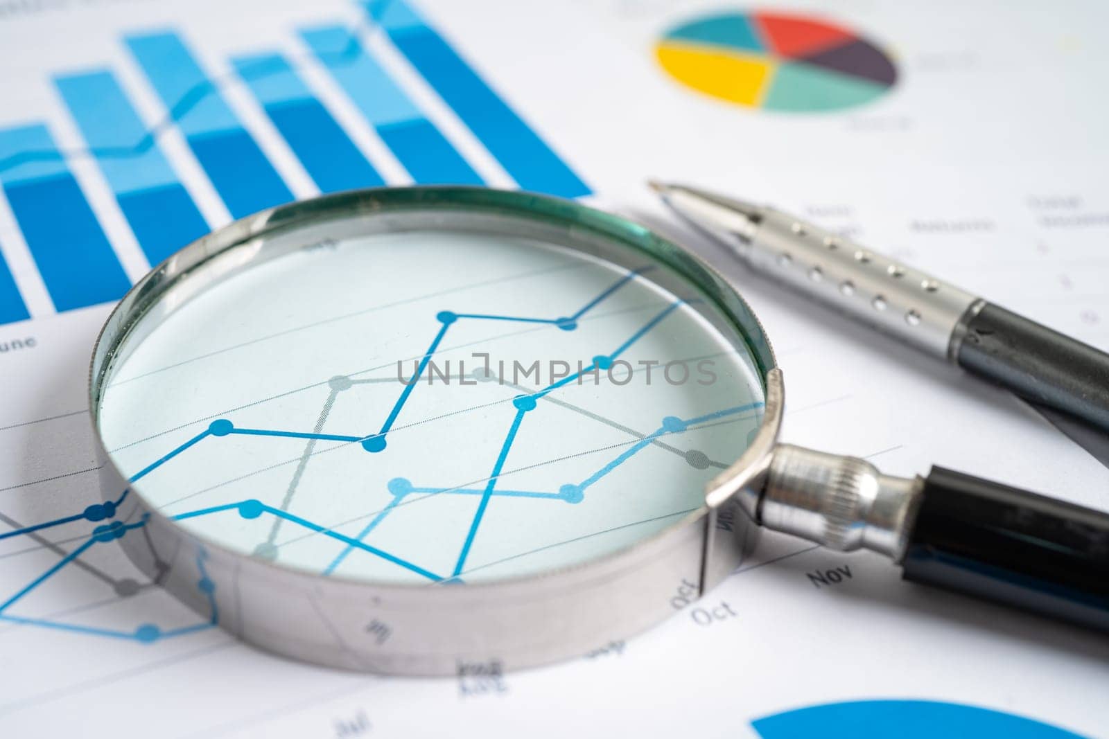 Magnifying glass on graph paper. Financial development, Banking Account, Statistics, Investment Analytic research data economy, Business concept.