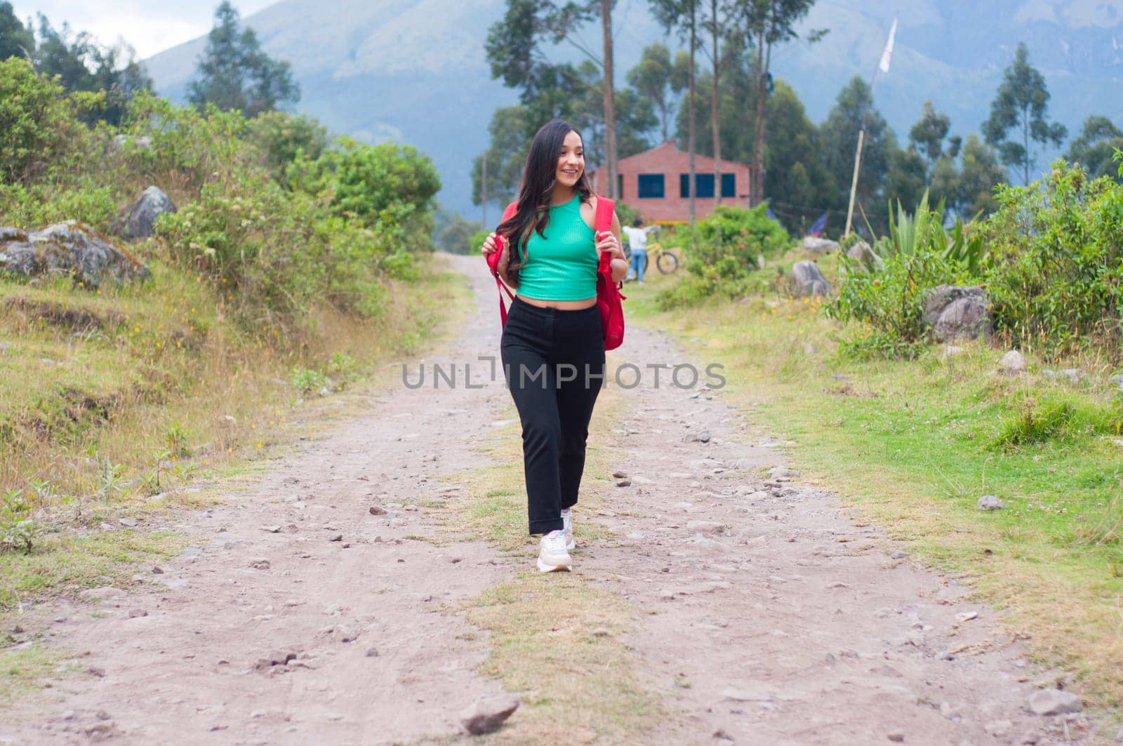 very happy young girl hiking in a mountain on her vacation with a view of a mountain. High quality photo