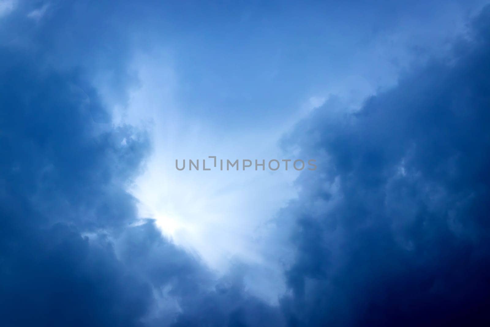 Sunbeam through the cloud on blue sky