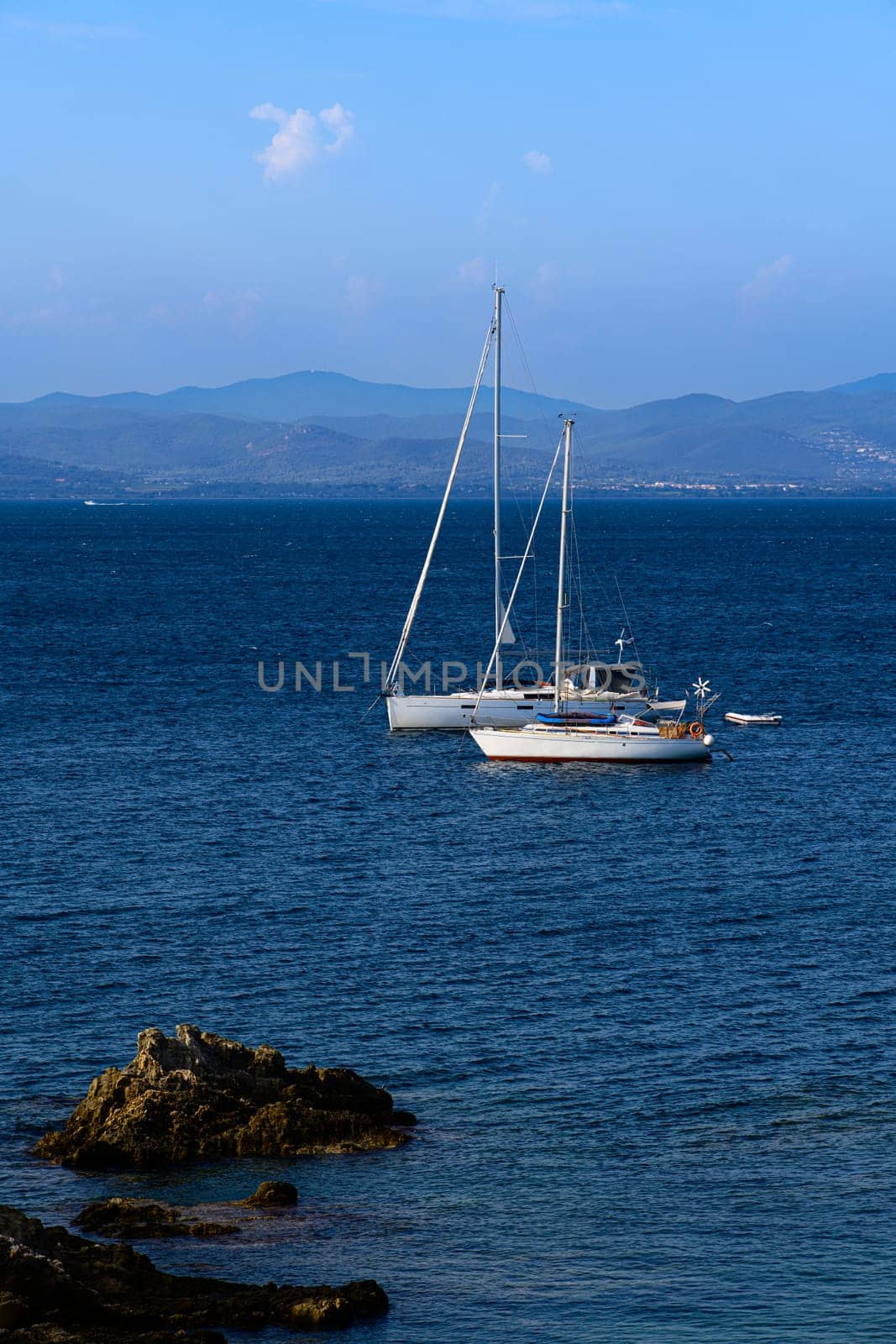 Majestic sailing ship resting in bay, surrounded by nature's beauty and calm waters.