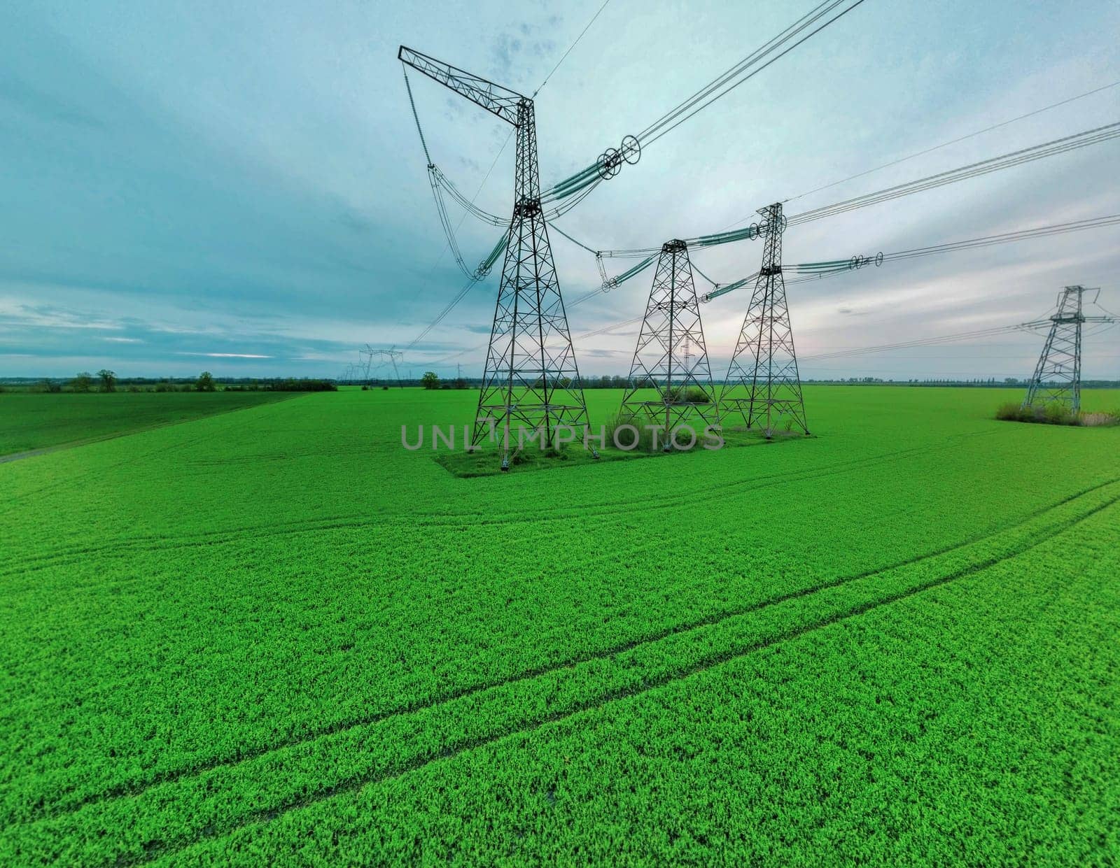 High voltage tower construction in green gield, beautiful landscape, blue sky, clean energy. global warming by igor010