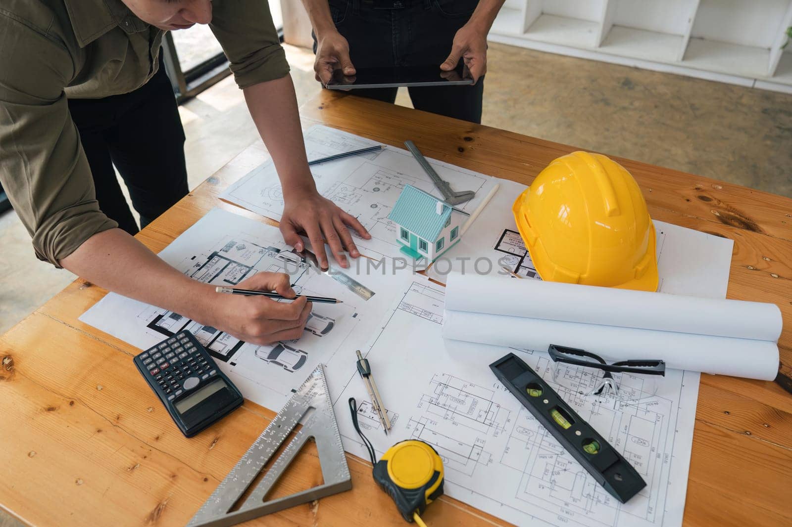 engineer team working in office with blueprints, inspection in workplace for architectural plan, construction project ,Business construction.