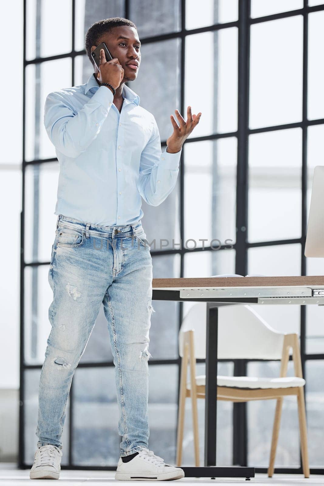 young man in a blue shirt talking on the phone