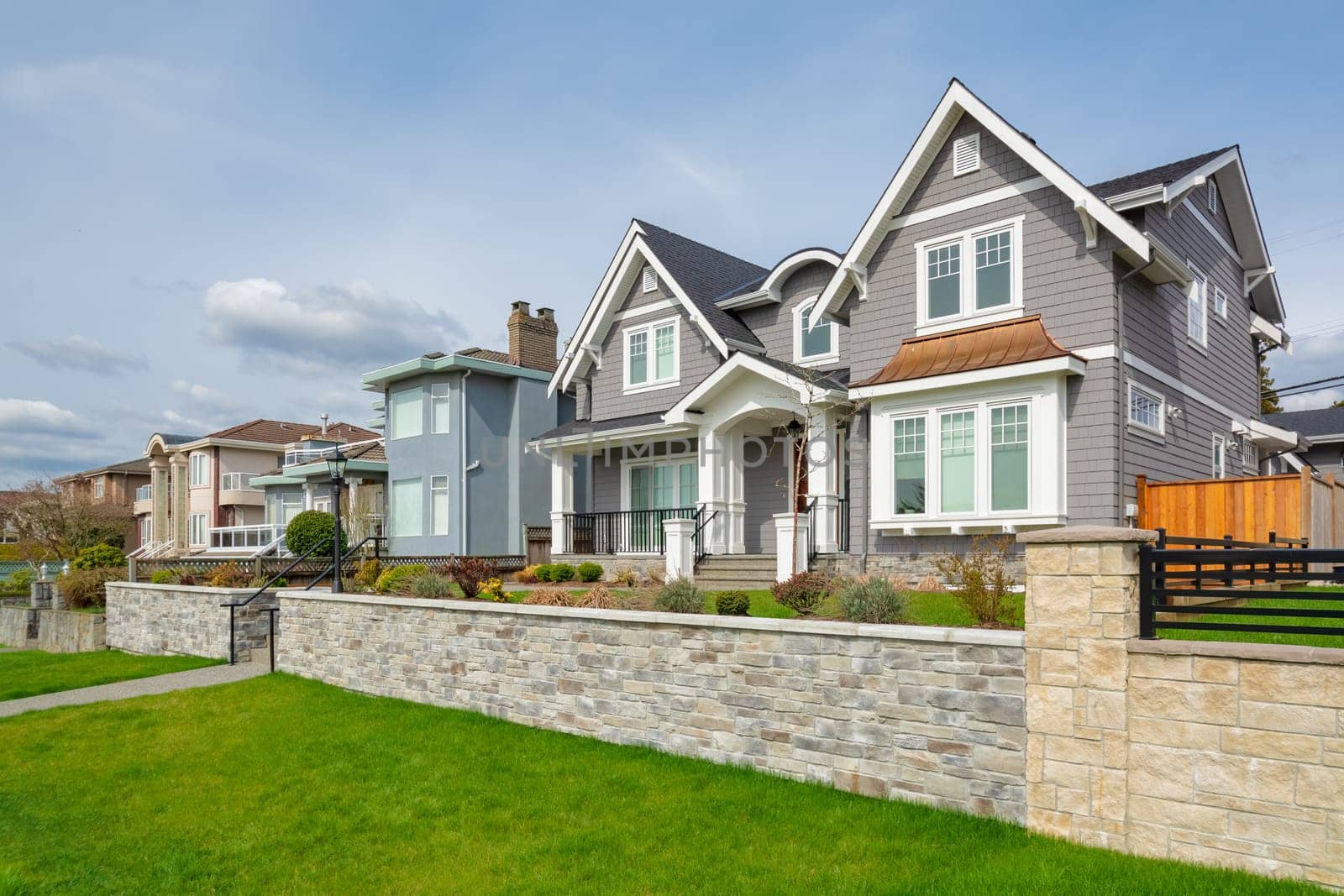 Luxury residential houses with landscaped front yard on land terrace