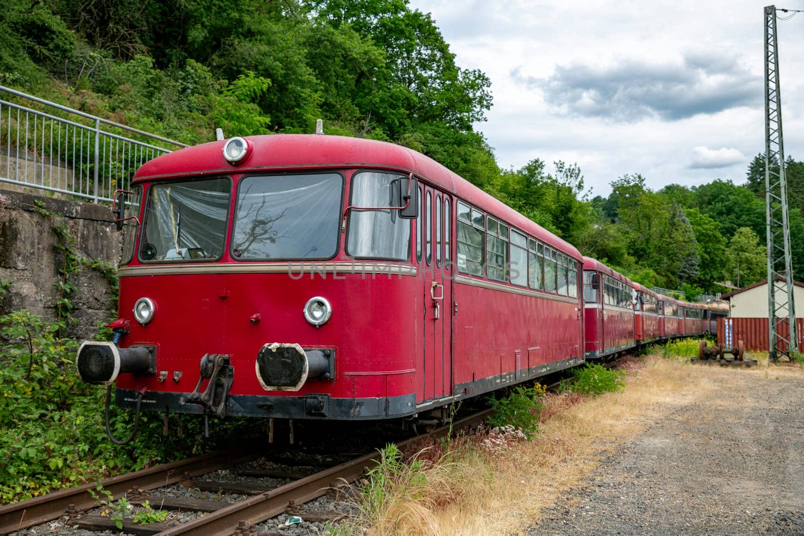 old red abandoned train on old station in linz in germany