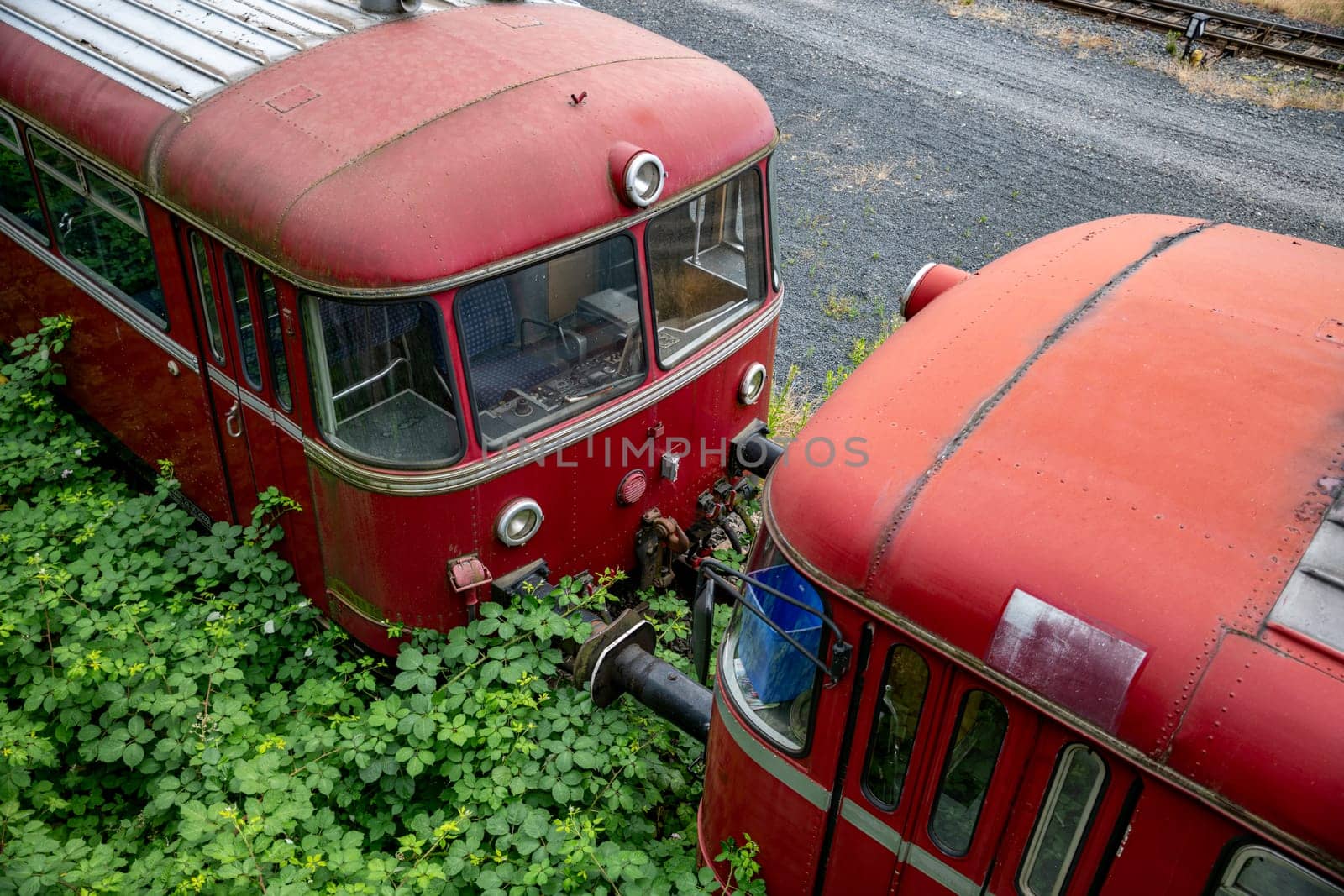 old red trains in station Linz am rijn in germany by compuinfoto