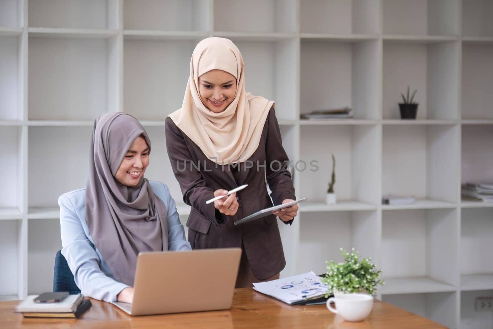 Professional Muslim business team working together, discussing on an important project in the office room. co-working concept..
