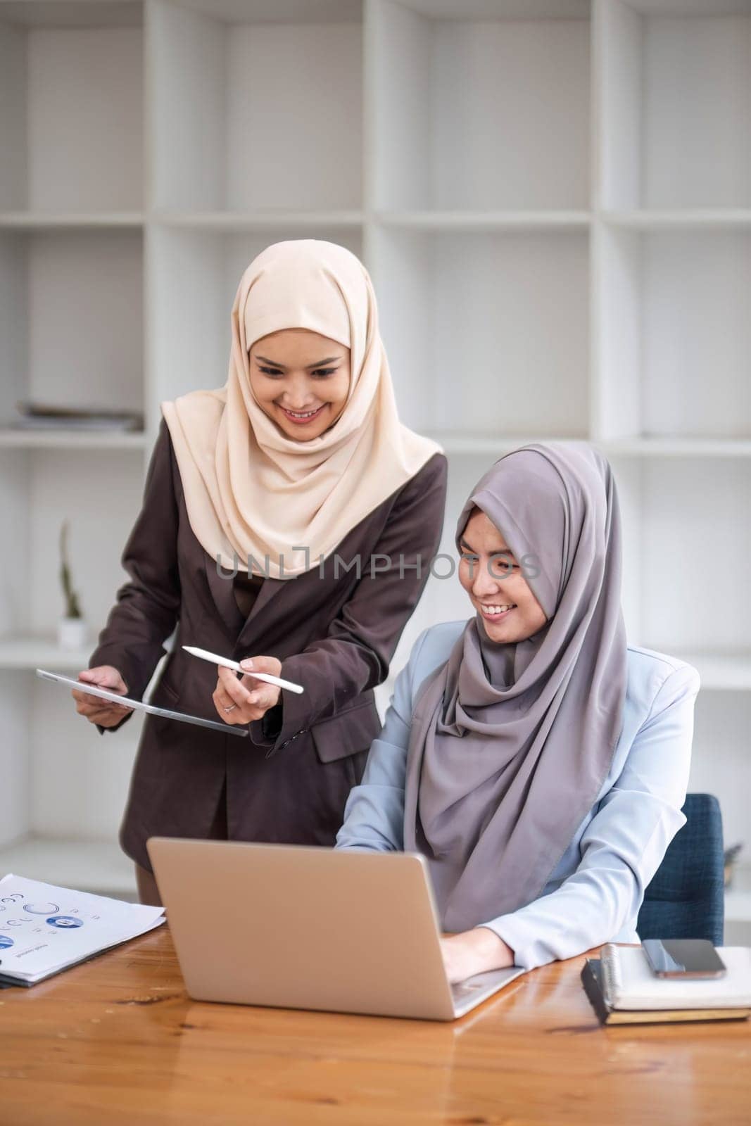 Professional Muslim business team working together, discussing on an important project in the office room. co-working concept by wichayada