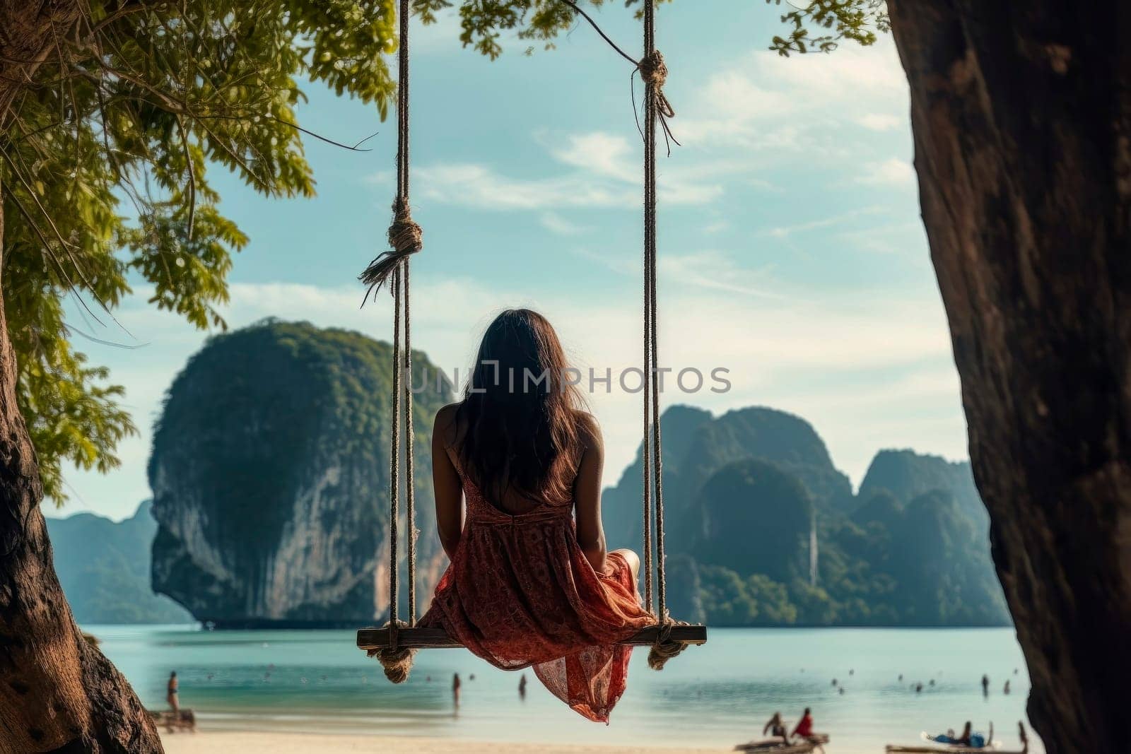 A traveler woman finds tranquility and relaxation as she swings above the crystal-clear waters of the Andaman Sea.