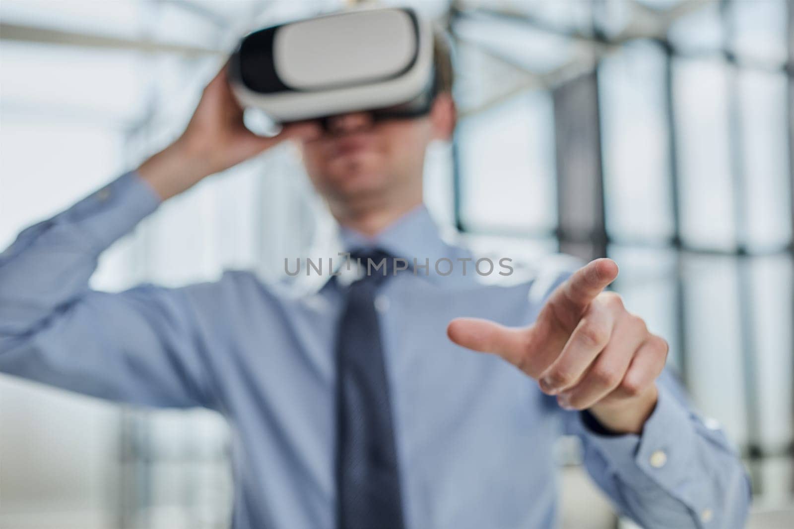young man testing VR glasses or goggles sitting in the office room