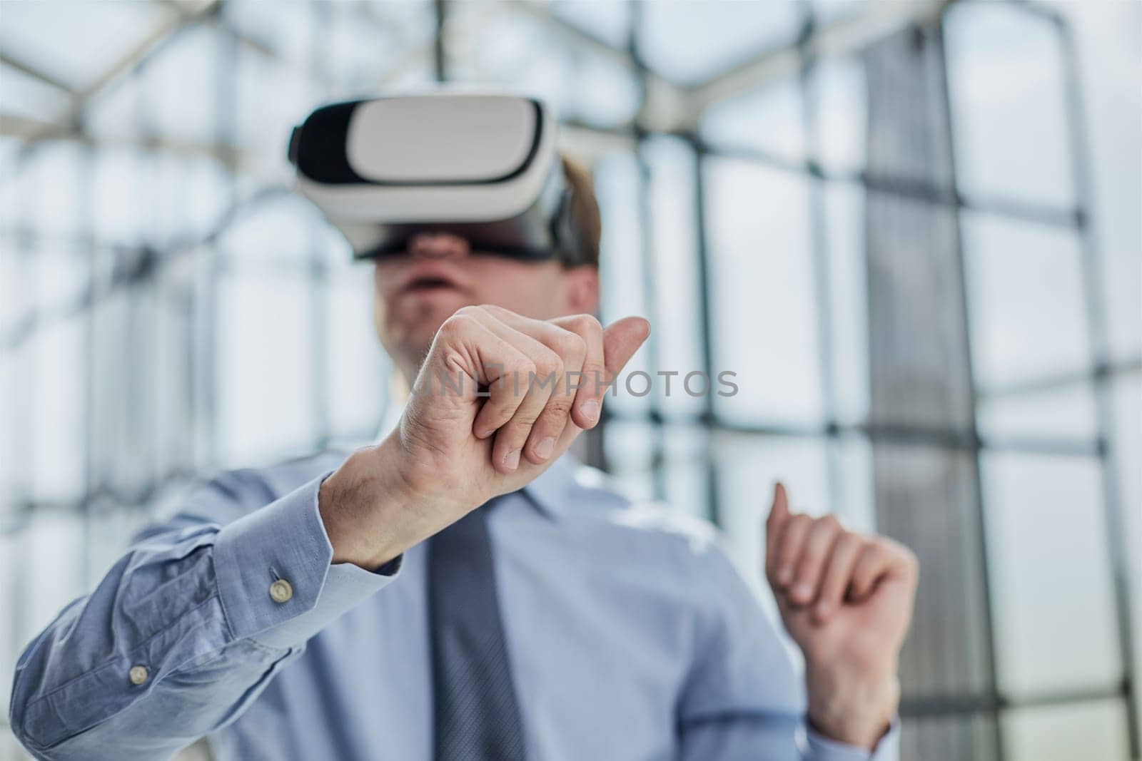 young man testing VR glasses or goggles sitting in the office room