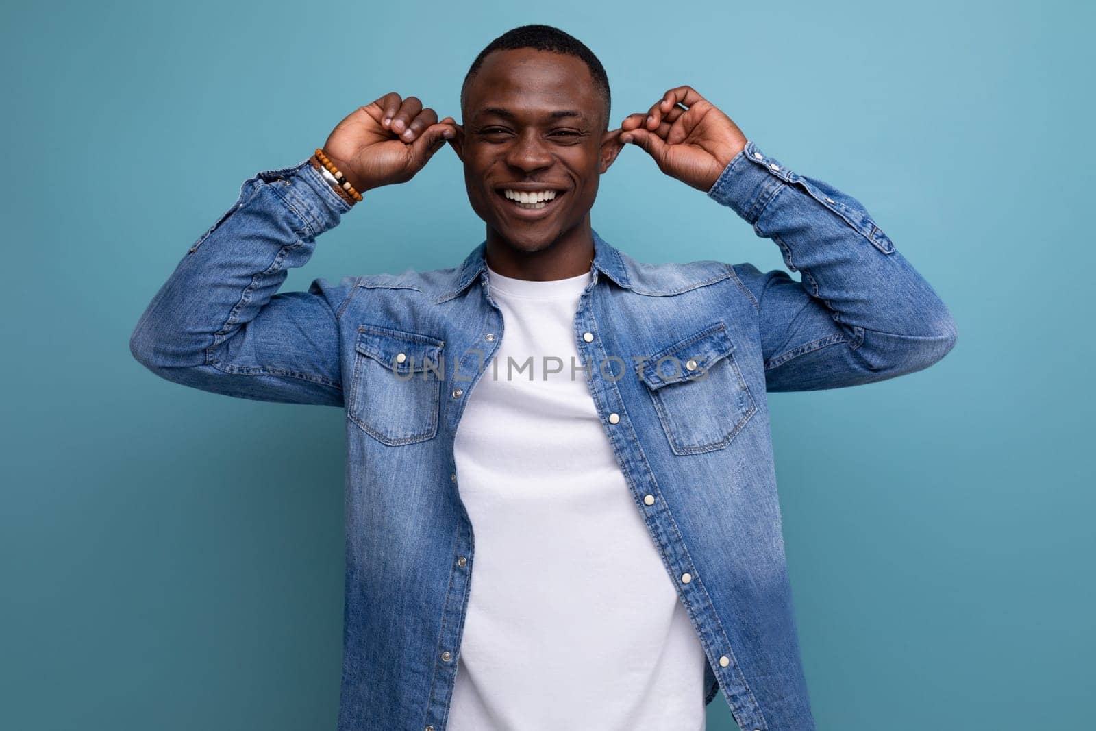 handsome confused young attractive african man dressed casually in denim.