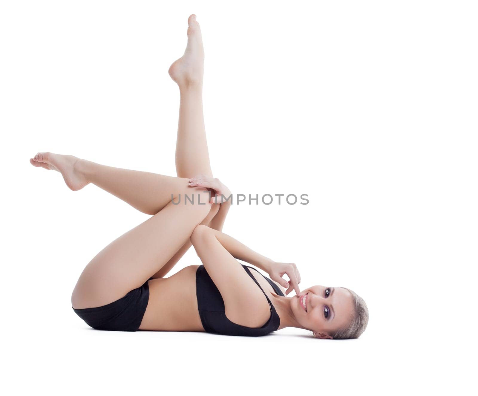 Studio shot of smiling beautiful fitness trainer, isolated on white