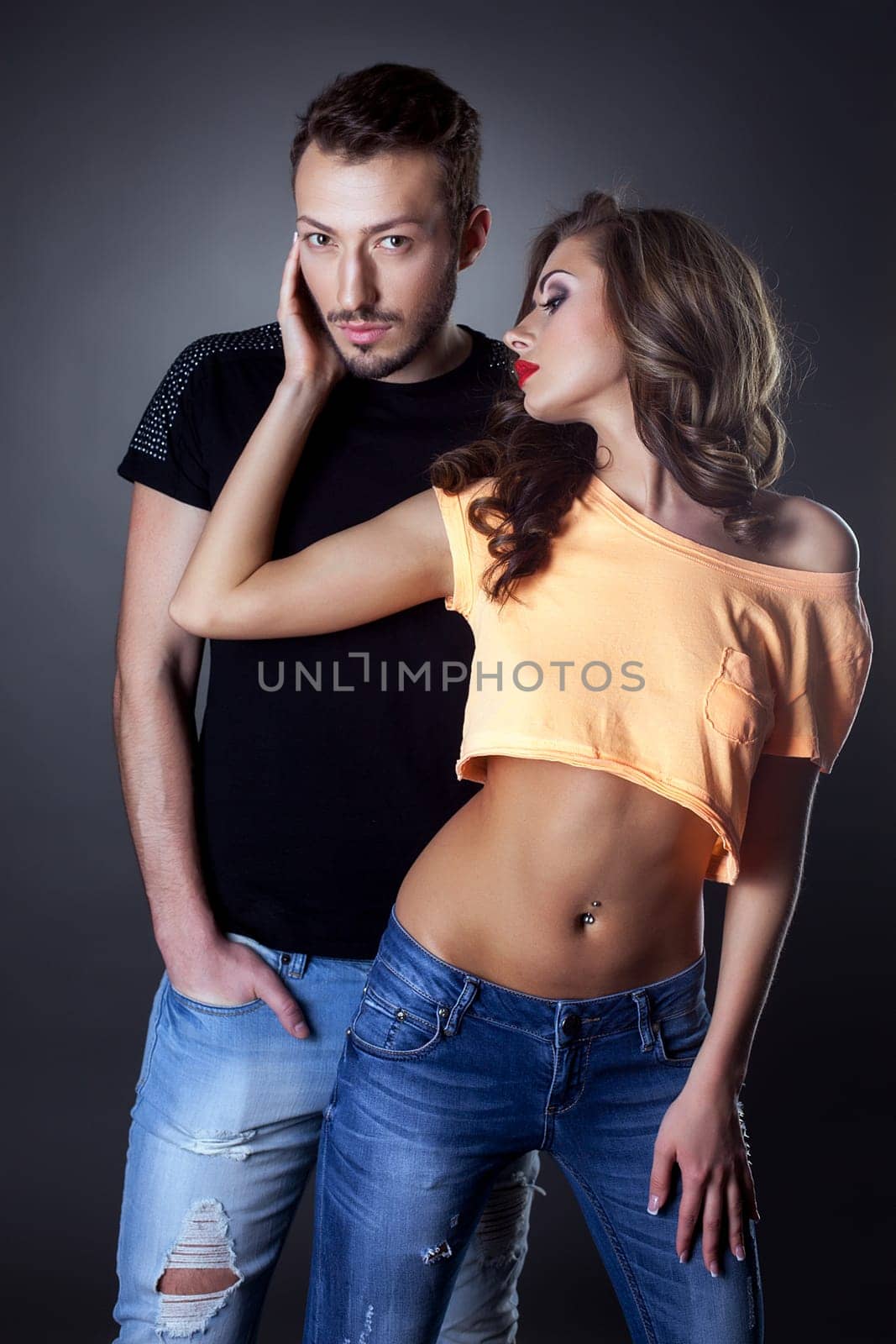 Couple of sexy handsome persons posing in studio
