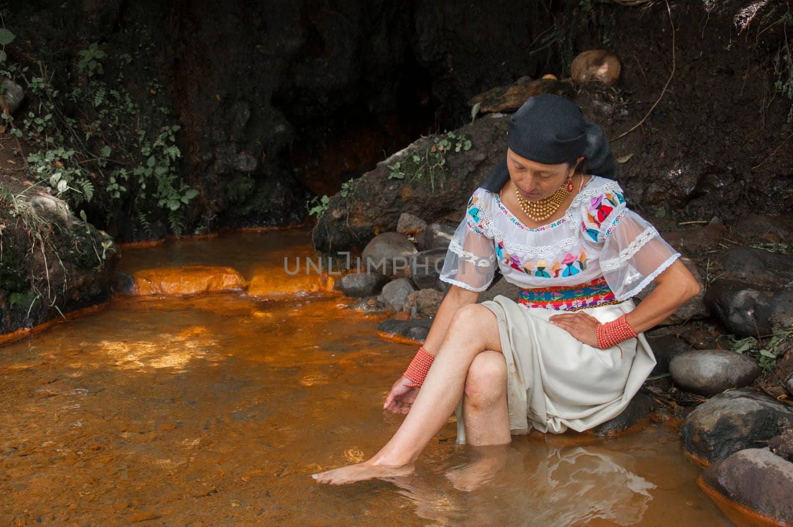 shaman woman in a sacred ritual in a place of meditation and harmony inside a lagoon. High quality photo