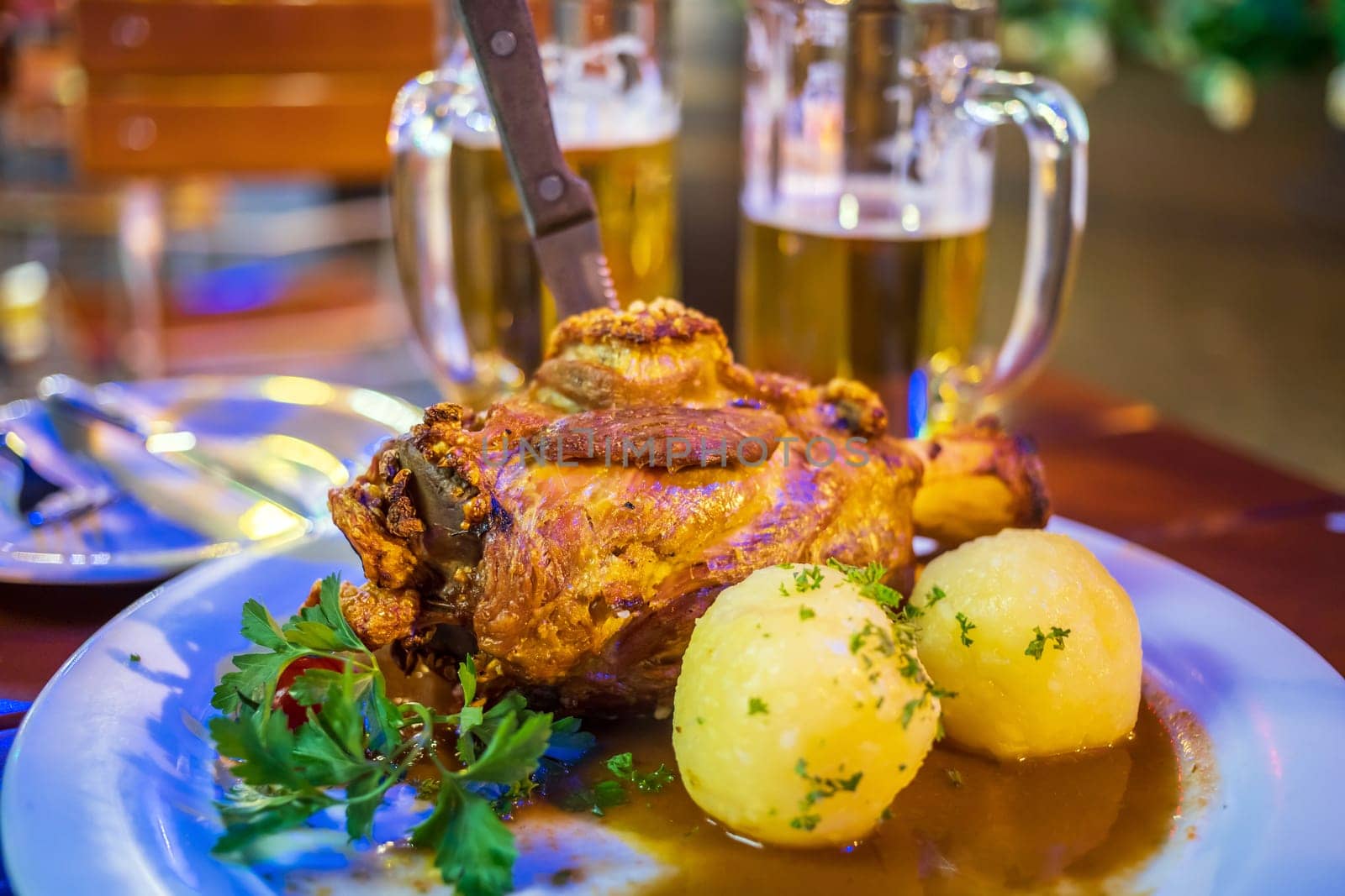 Deep fried pork knuckle  in Frankfurt, German with potato and beer 