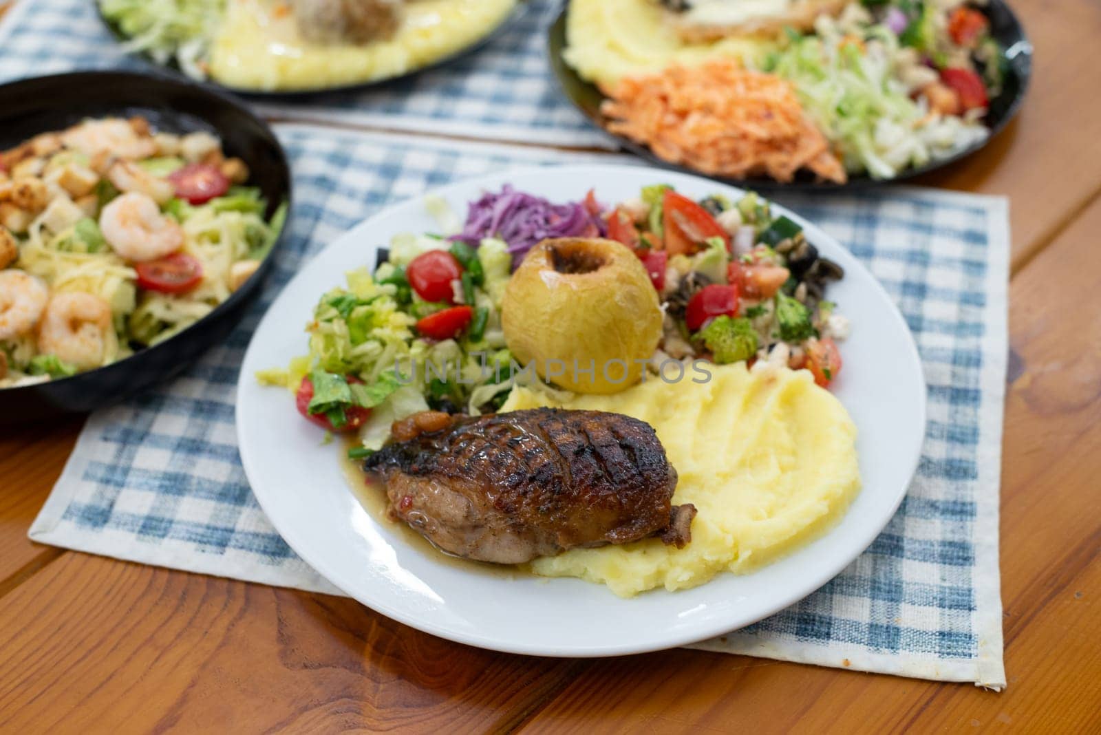 Home made meat dish with salads, in hands dinner time duck and apple. High quality photo