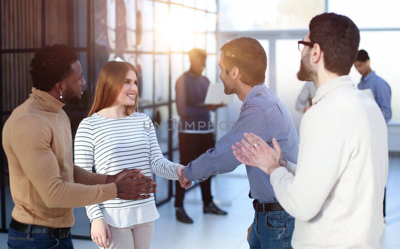 Diverse multiracial colleagues talk in groups discuss ideas at casual team meeting in office. by Prosto