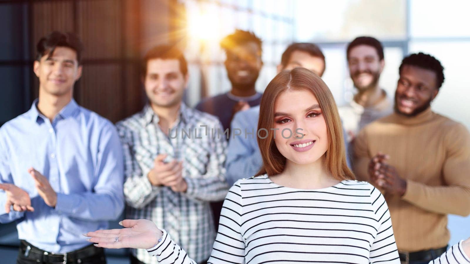 the team slaps the leader to the woman in the foreground. Success concept