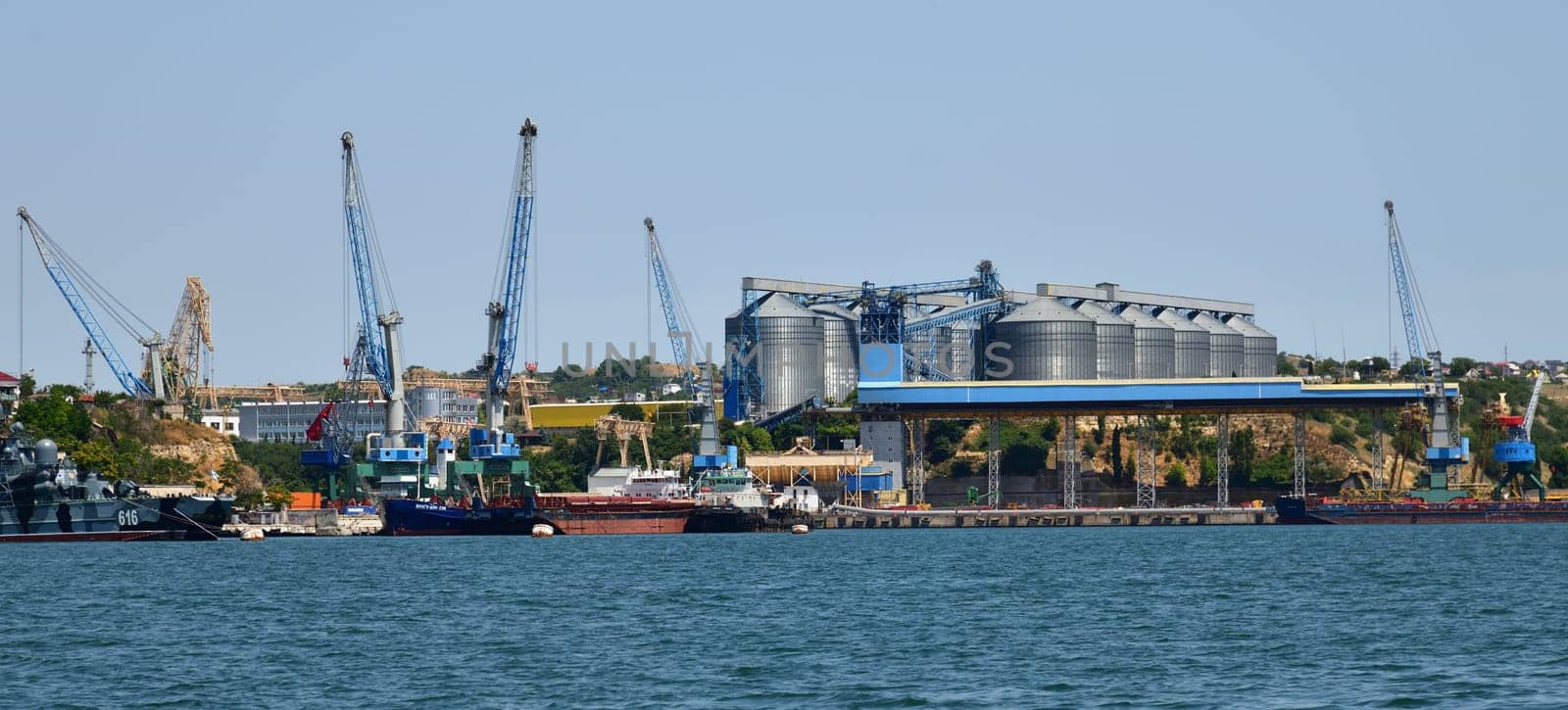 Sevastopol, Crimea - July 3, 2019. Grain terminal and Dock bay with cranes for ship repair by olgavolodina