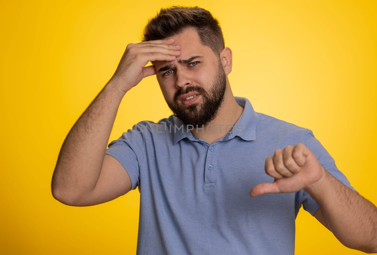 Bearded caucasian man feeling hopelessness loneliness, nervous breakdown, loses becoming surprised by lottery results, bad fortune loss, unlucky news. Young guy isolated on studio yellow background