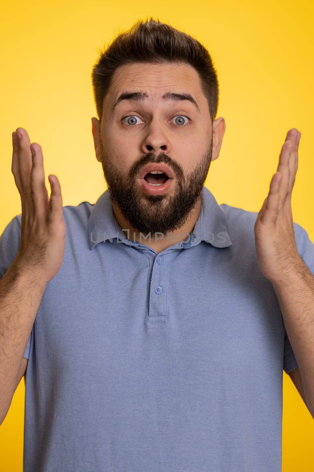Oh my God, Wow. Excited amazed winner man surprise looking at camera with big eyes, shocked by sudden victory. Sincere confused shocked caucasian guy isolated on yellow studio background. Vertical