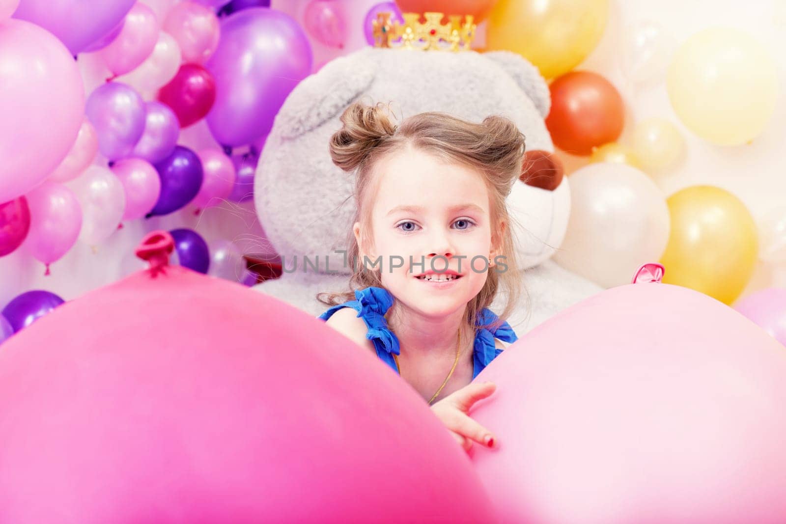 Portrait of beautiful little girl posing in playroom
