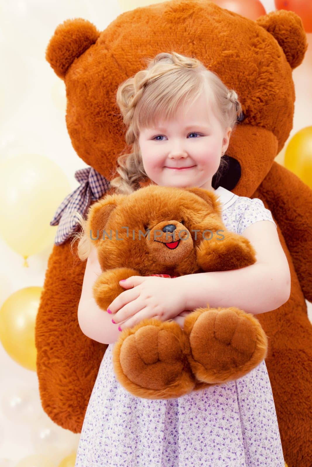 Image of charming little girl hugging favorite toy