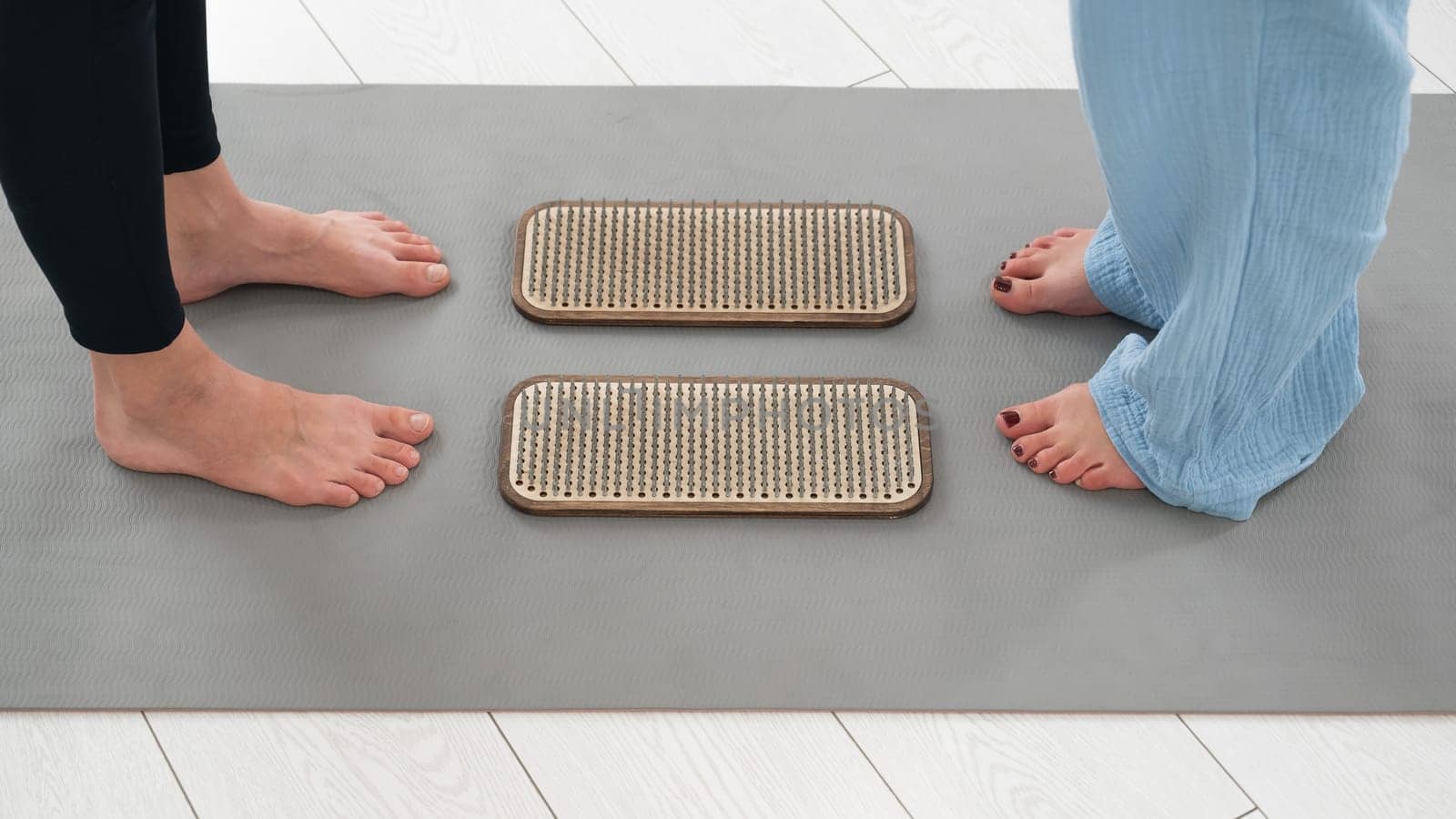 Female feet next to sadhu boards in yoga studio