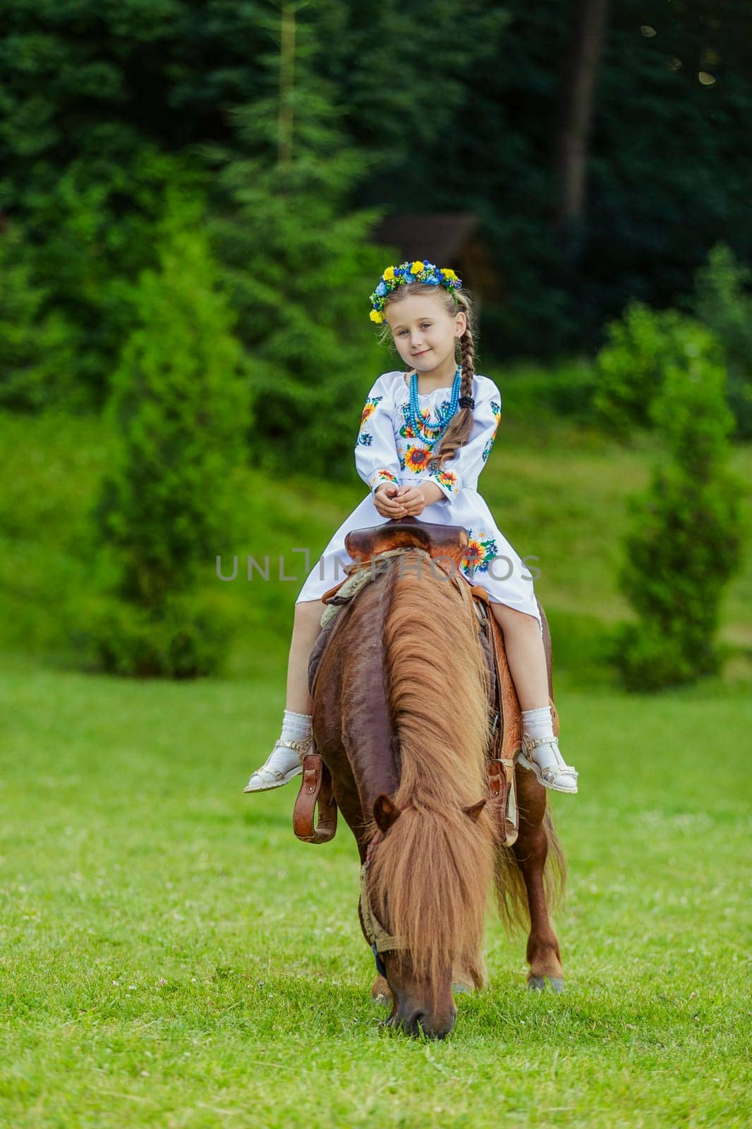 little girl riding a pony