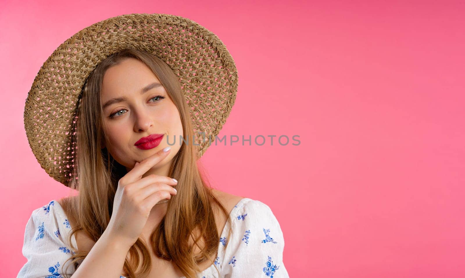 Thinking around woman on pink background. Smart student girl finding answer or trying to remember what she forgot, memory concept. Copy space. High quality