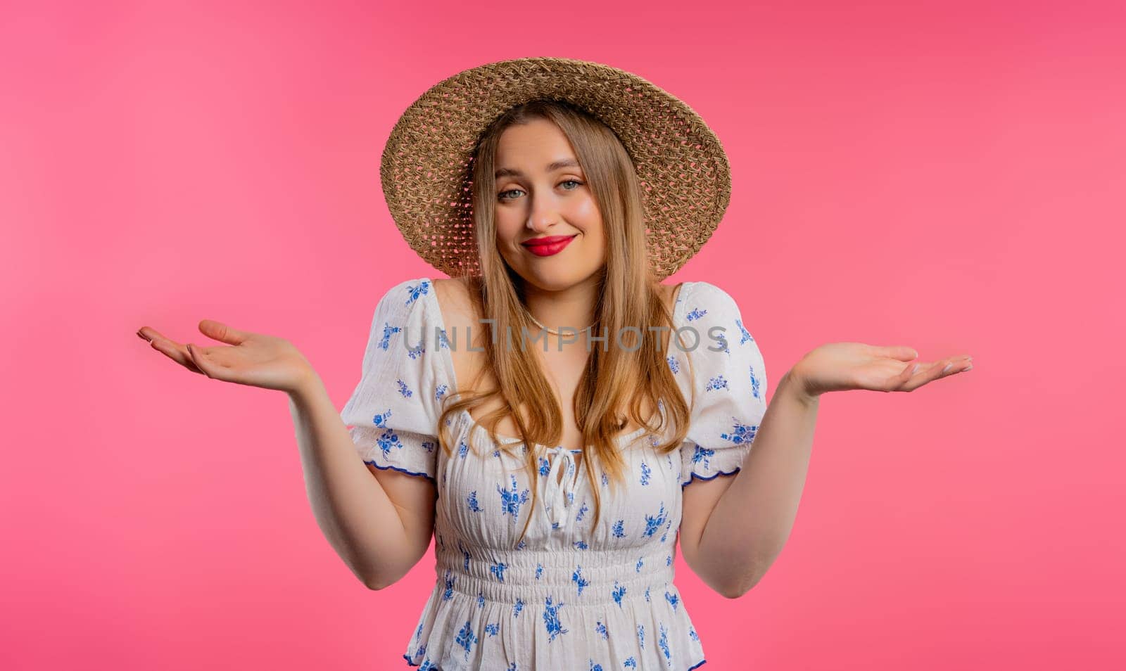 Confused pretty woman, shoulders up - can't help, makes gesture of I dont know. Difficult question, guilty reaction, puzzled stylish woman on pink background. High quality