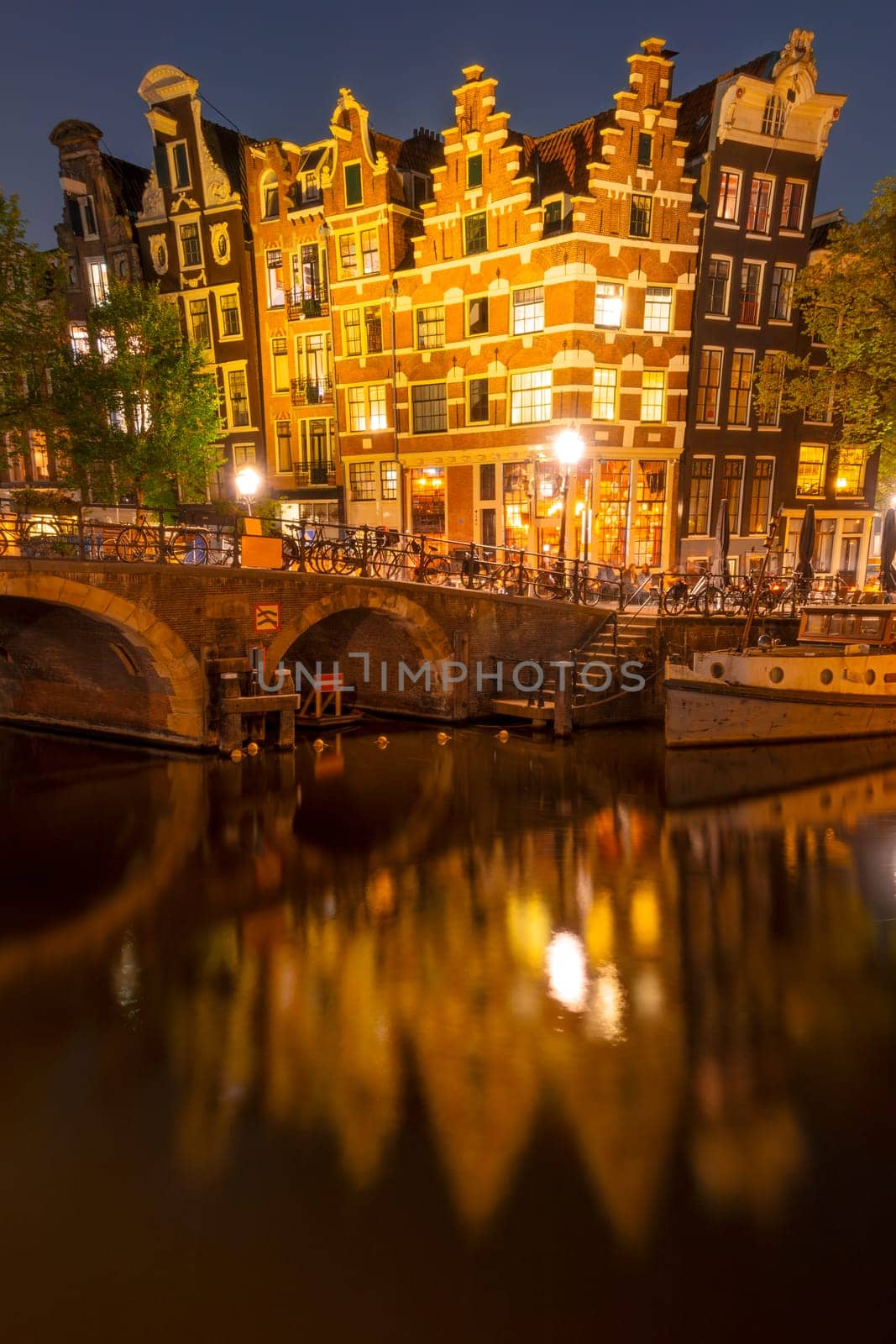 Dancing Dutch Houses on Amsterdam Canal at Night by Ruckzack