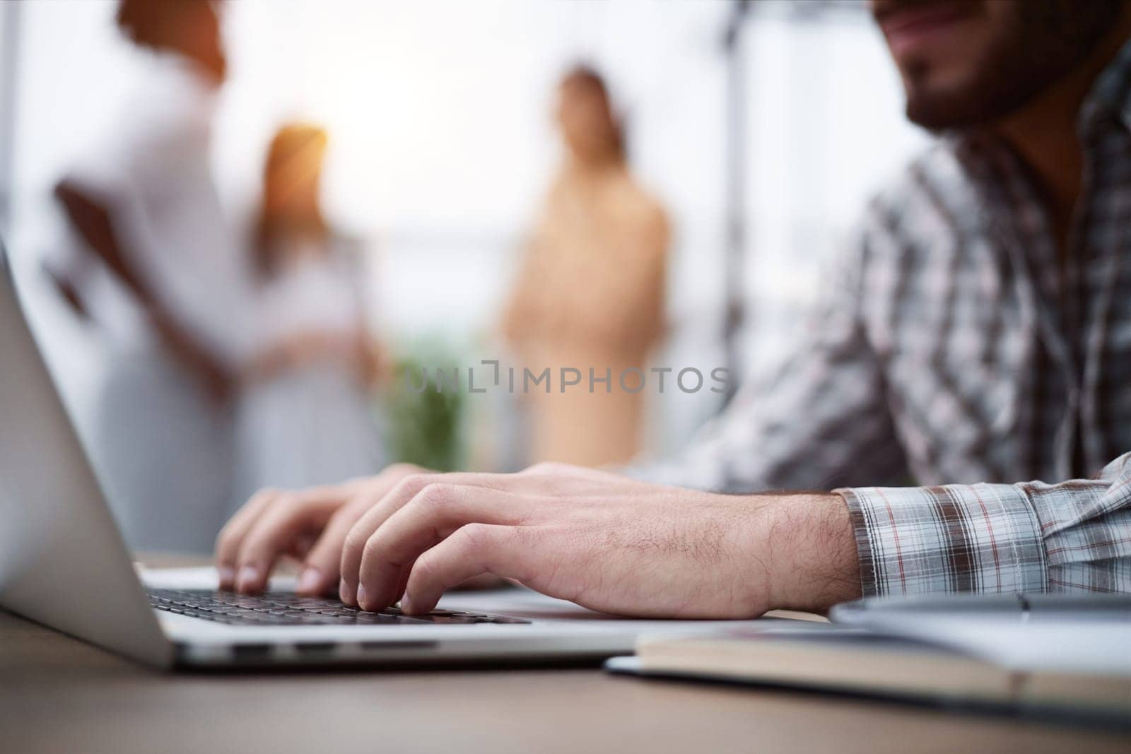 Side view shot of businessman working by using a laptop computer on table. by Prosto