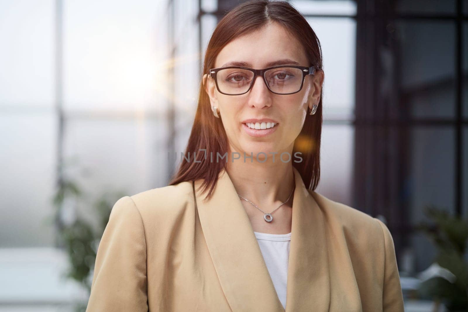 Attractive woman looking pensively at the camera in office