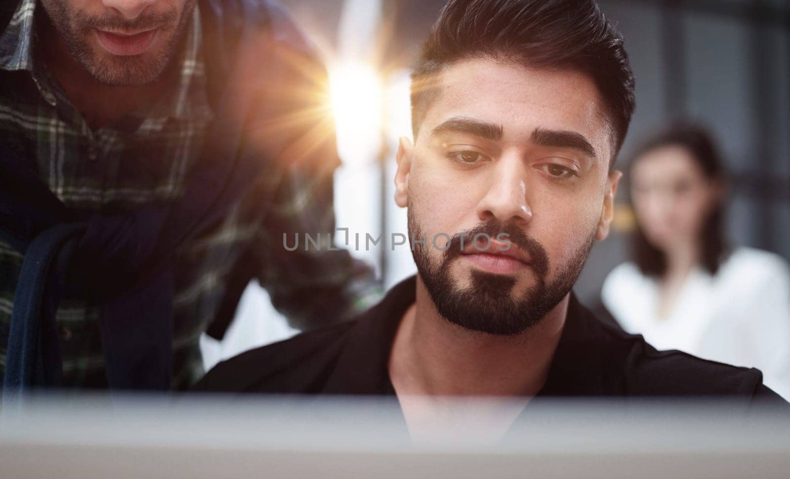 Businessman using a laptop while working late in his office