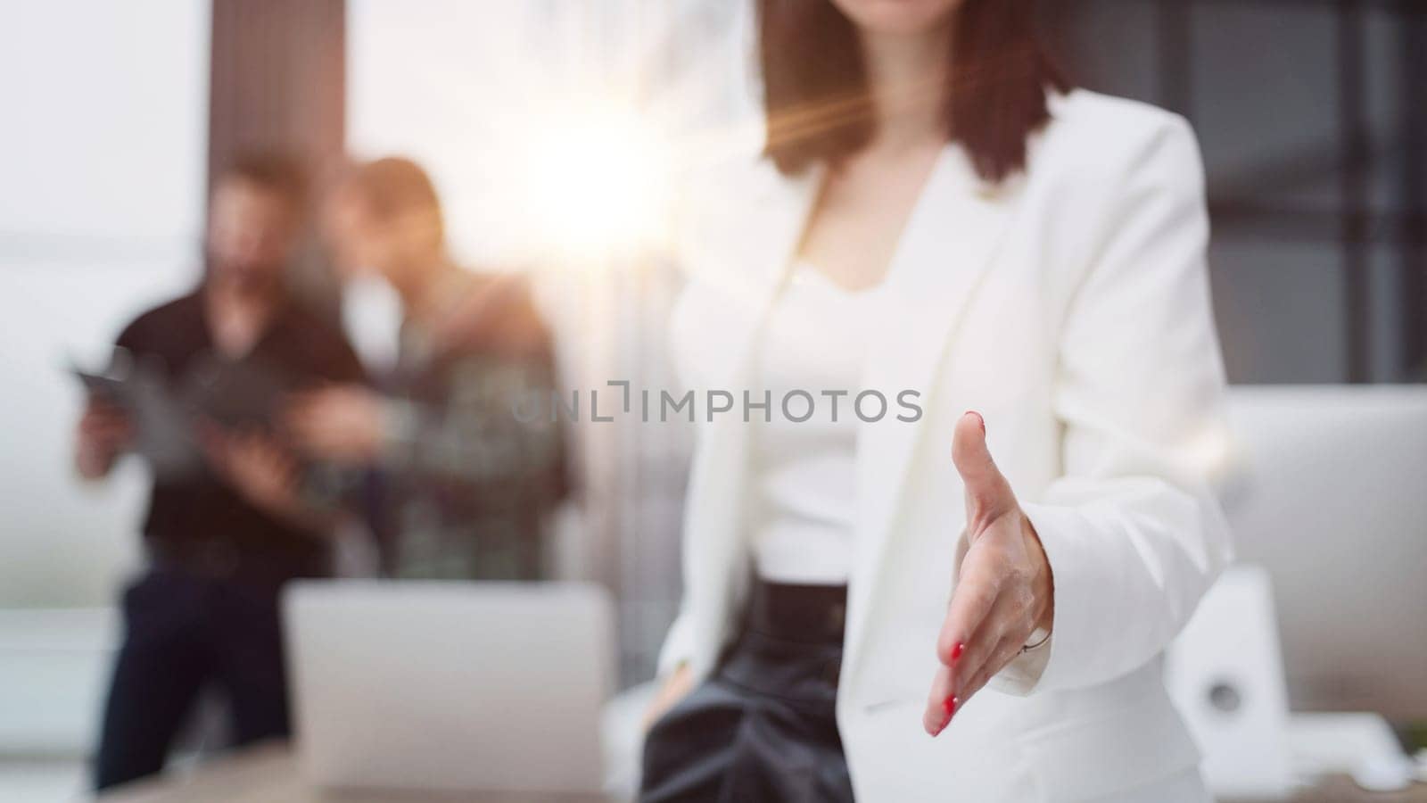young business woman greets a colleague with a handshake. by Prosto