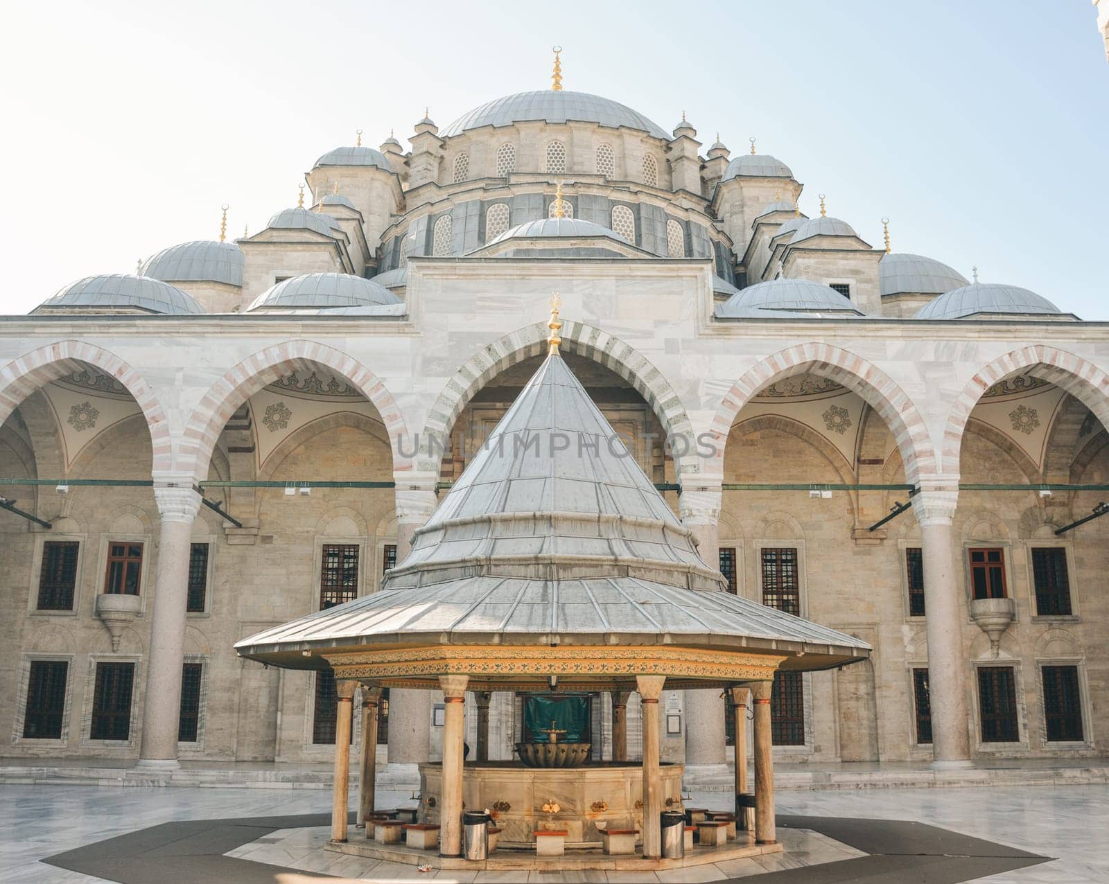 Fatih Mosque or Conqueror's Mosque in Istanbul, Turkey. Beautiful Fatih camii is landmark of Istanbul. Panorama of mosque courtyard, old muslim Turkish architecture. Travel, culture and tourism theme by Ekaterina34