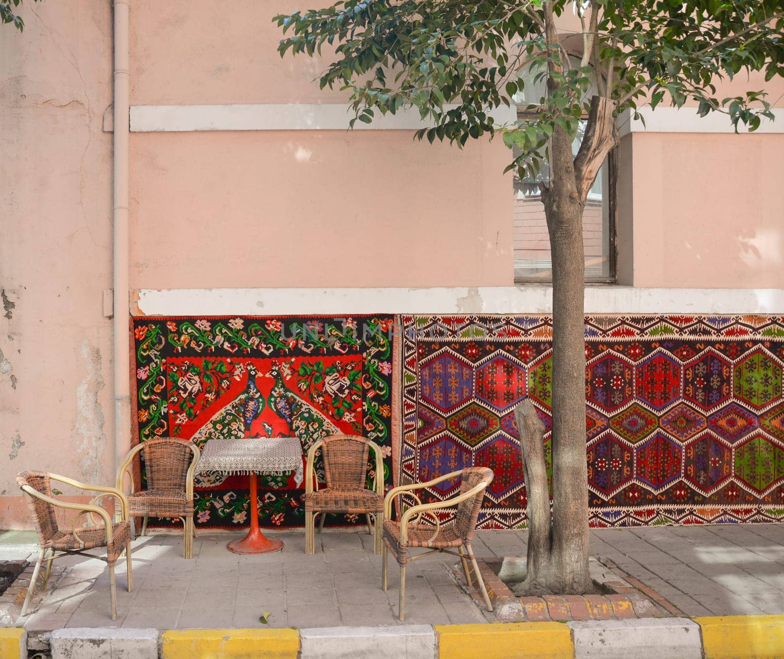 Beautiful street cafe in Turkey with colorful carpets.