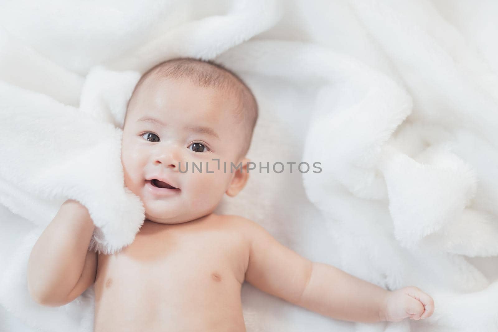 portrait asia baby on white bed