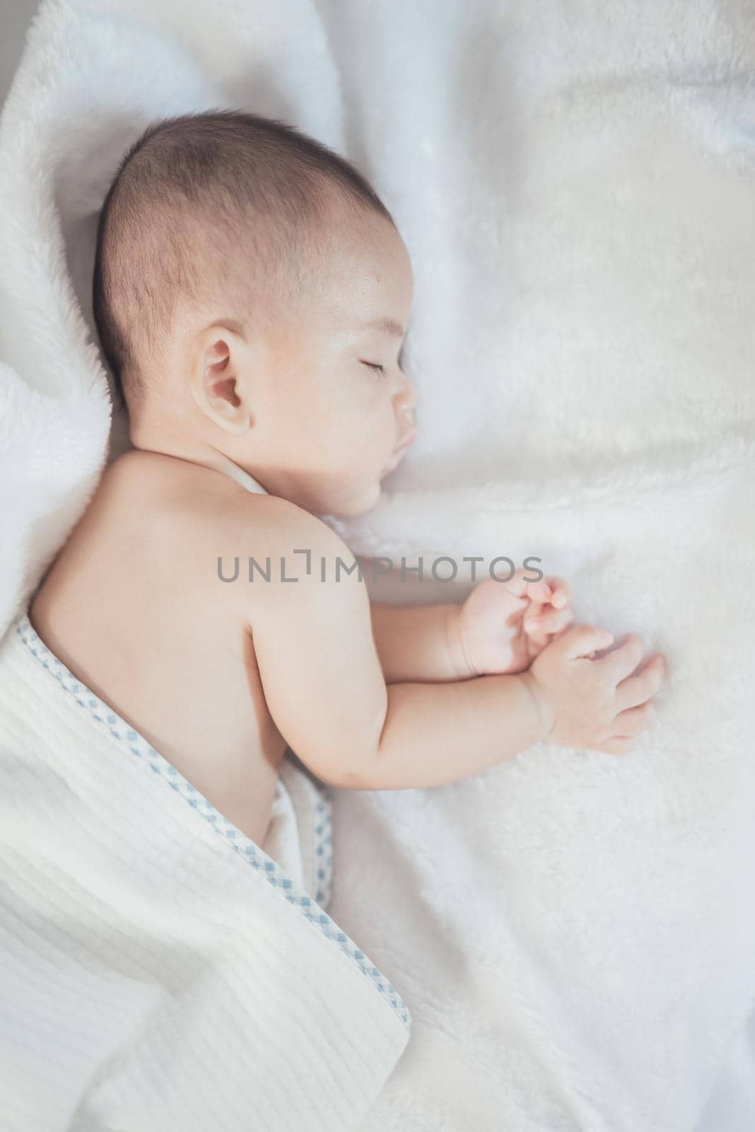 portrait asia baby on white bed by Wmpix