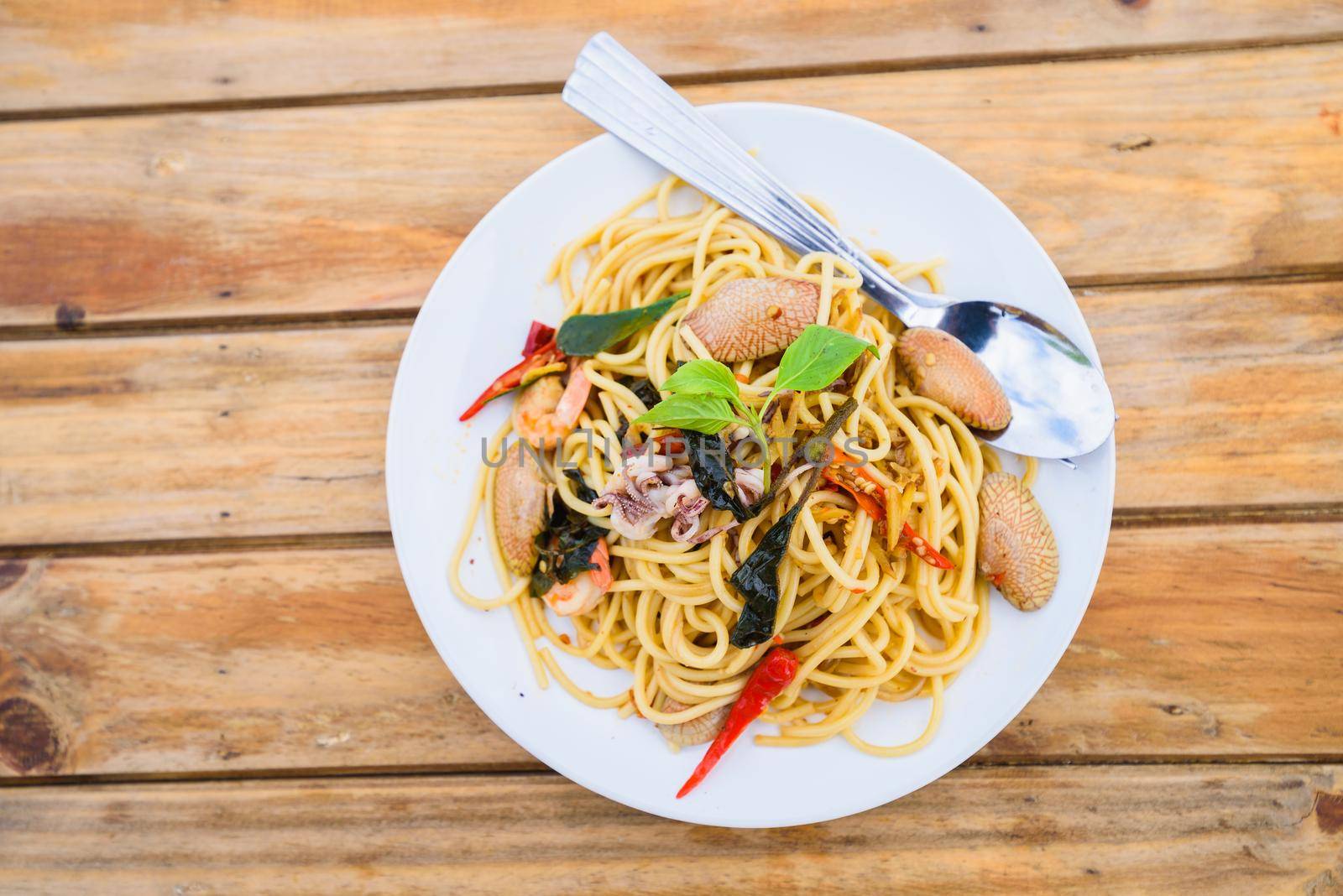 spagetti seafood spicy on wood table