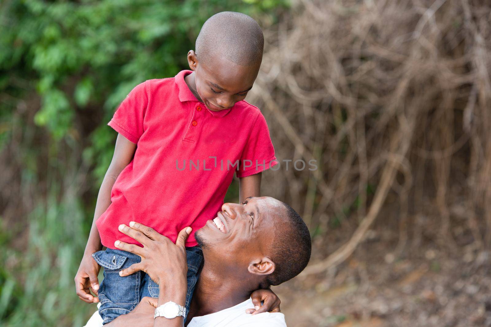Portrait of father with his son having fun in the park. Family fun happy boy playing with dad outdoors in nature