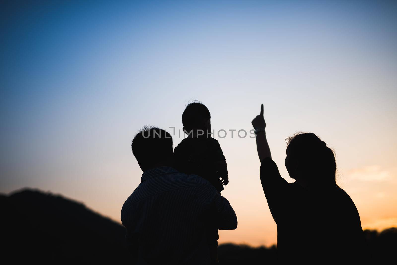 silhouette of family at sunset