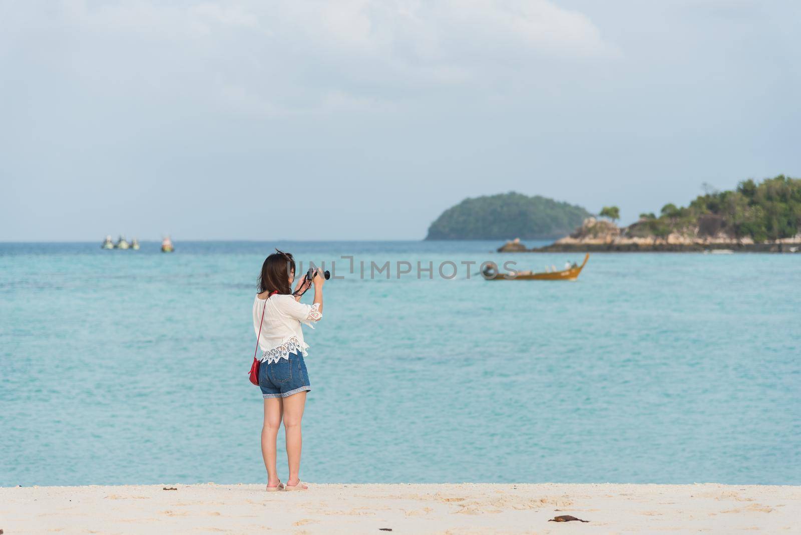asia girl take photo on the beach