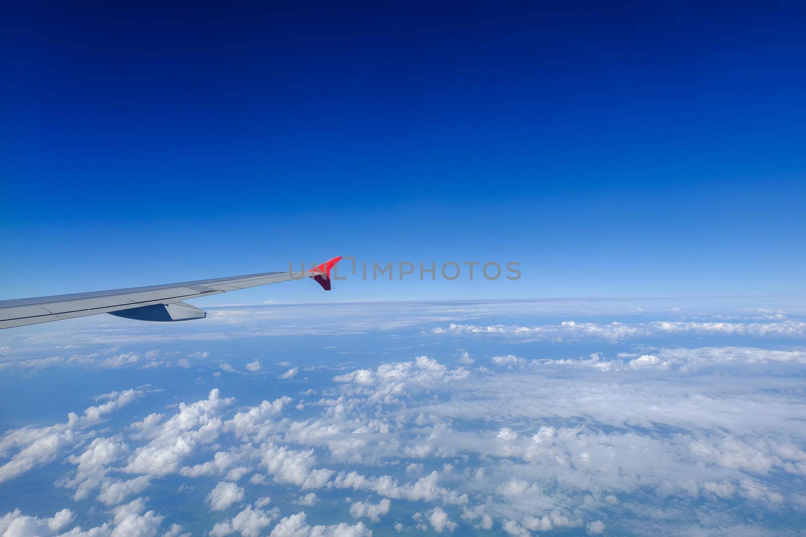clouds and blue sky seen from plane by Wmpix